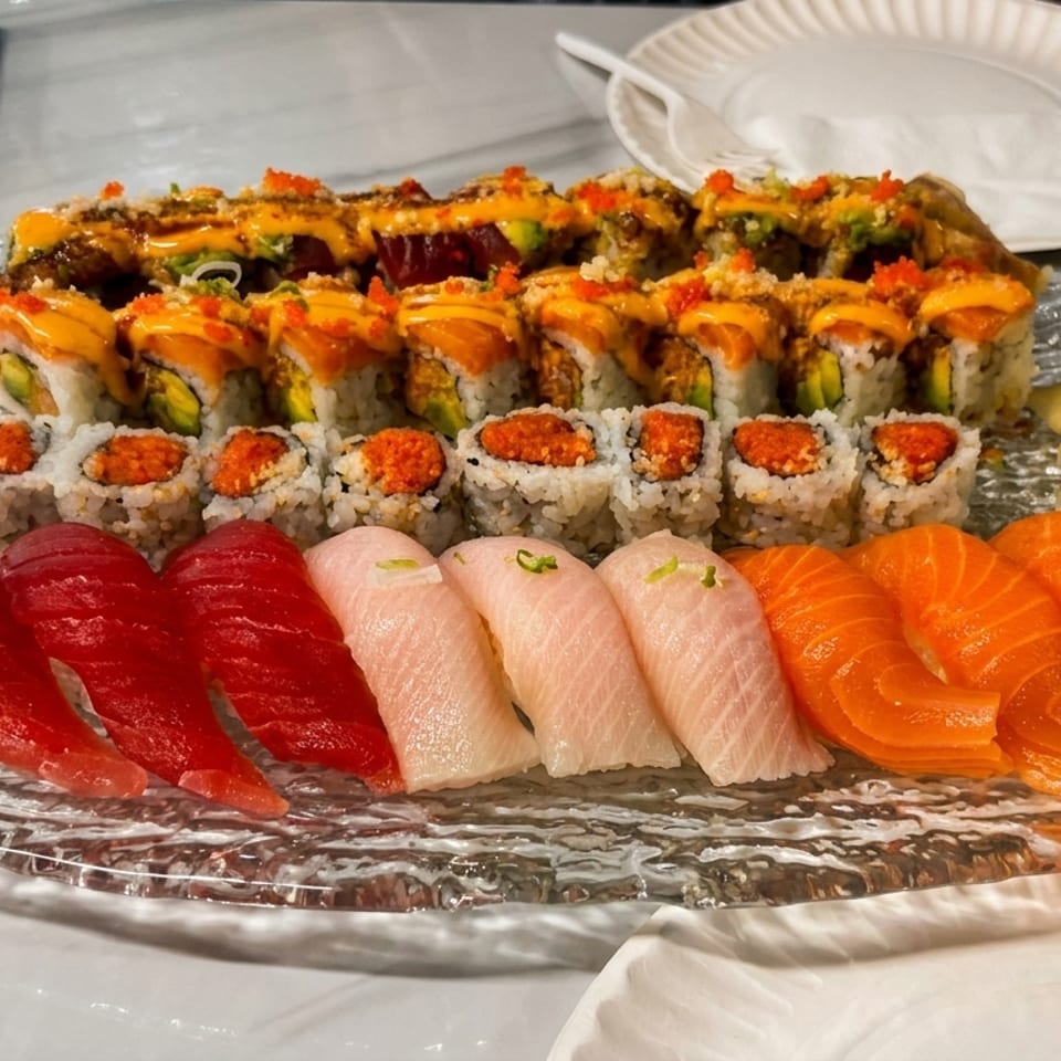 A large platter of various sushi rolls and nigiri, including tuna, salmon, and yellowtail.
